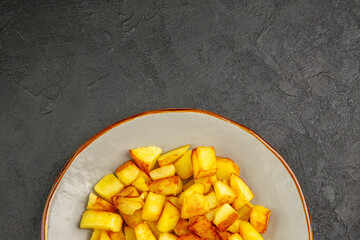 top view delicious fried potatoes inside plate on dark background oil french fries food photo color dinner