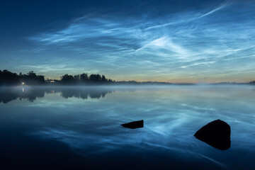 Noctilucent clouds over lake.