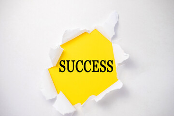 a white torn sheet in the center of which is a yellow background with the inscription success. Concept photo