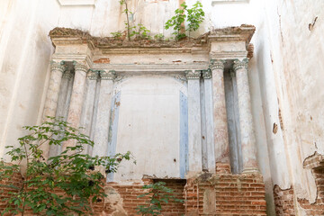 Fototapeta na wymiar Old dilapidated old dilapidated building with red brick columns. An old Church or Church with frescoes on the walls. Historical value and heritage of Freemasonry.