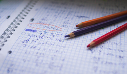 Office. Study. Colored pencils on paper. Formula sheet. Mathematics. Notebook on rings.