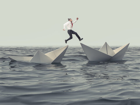 man jumps from a sinking paper boat to a floating one.
