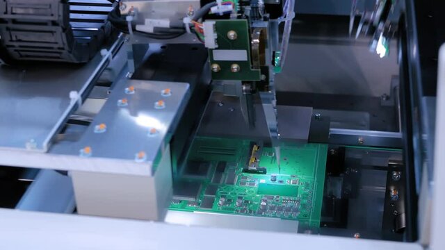 Automated technology, industrial, robotic, electronic, production, manufacturing concept. Automation machine equipment for quality testing of printed circuit boards - flying probe test at factory.