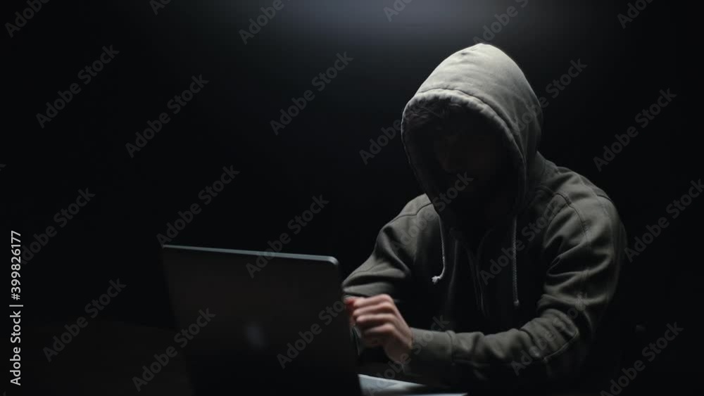 Wall mural remote view of unrecognizable hacker man stretching hands and starting to typing on laptop computer 