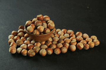 Hazelnuts on wooden backdrop. heap or stack of hazelnuts. healty food