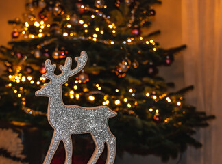 Festive Christmas decoration with raindeer and blurred lights in the background