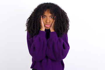 Young beautiful African American woman wearing knitted sweater against white wall Tired hands covering face, depression and sadness, upset and irritated for problem