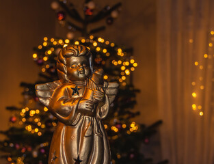 Festive Christmas decoration with angel and blurred lights in the background