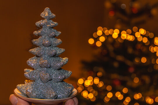 Festive Christmas decoration with Christmas tree and blurred lights in the background