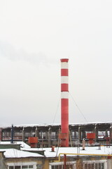 Abandoned industrial zone against cloudy gray sky.