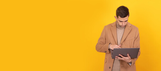 young man with laptop isolated on background