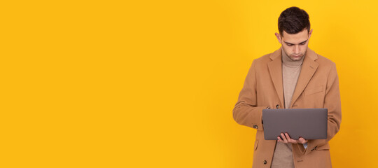 young man with laptop isolated on background