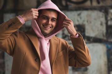 Fototapeta na wymiar young adult man in coat on the city street