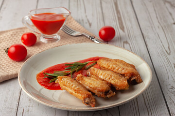 Buffolo wings with tomato sauce and rosemary sprig