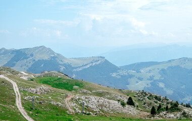 Fototapeta na wymiar Beautiful view of the peaks of Monte Baldo. Stunning cloudy and panoramic view. Green Pastures in Italian Alps