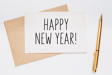 happy new year note with envelope and gold pen on white background. merry christmas and New Year concept