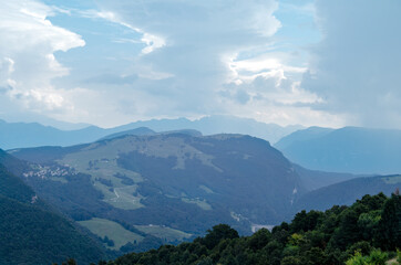 Beautiful view of the peaks of Monte Baldo. Stunning cloudy and panoramic view. Green Pastures in Italian Alps
