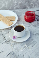 Crispbread with jam for Breakfast on a gray background. A jar of Fresh Honey with foam is next to a Cup of coffee. A minimum of calories. proper nutrition