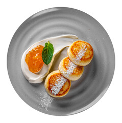 cheese pancakes with sour cream and strawberry sauce on plate isolated on white background