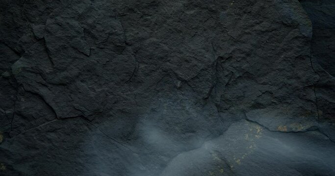 Looped black background with dark stone texture. Harsh, brutal and rough black backdrop.