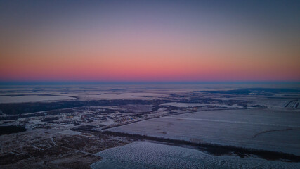 beautiful sunset in a winter frosty field