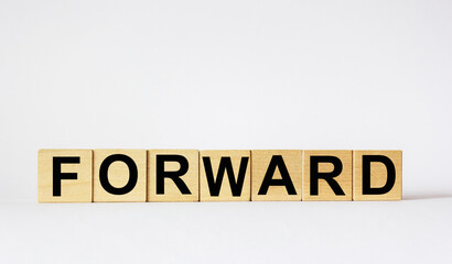 Word FORWARD on wooden cubes and white background. White background, copy space.