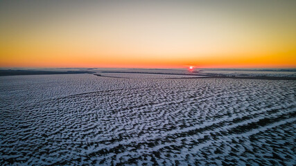 beautiful sunset in a winter frosty field
