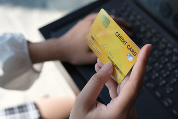 woman holding credit card and use laptop for with shopping online. Online payment concept.