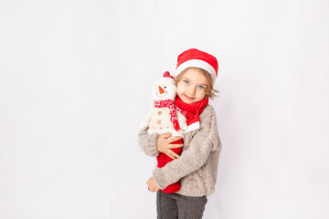 little girl in a Santa hat with a snowman on a white background, space for text