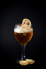 Delicious cocktail with orange on black background