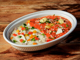 Paneer begam bahar, is a famous indian dish, served over a rustic wooden background, selective focus