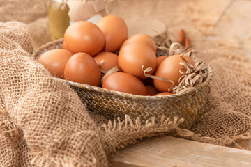 Fresh chicken eggs on a wooden table.