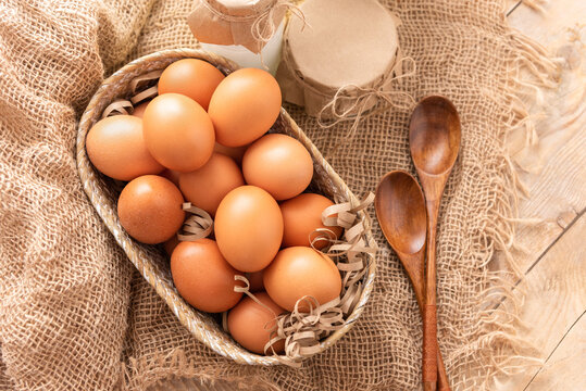 Fresh chicken eggs on a wooden table.