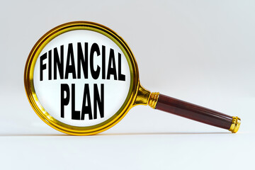 Magnifier on a white background, inside the text is written - FINANCIAL PLAN