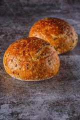 Assortment of baked bread on wooden table background Fresh fragrant bread on the table. Food concept.