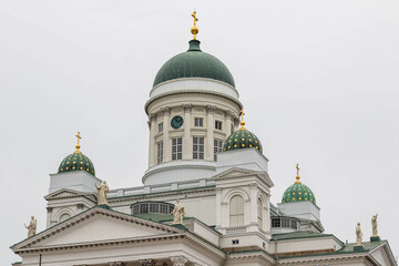 Fototapeta na wymiar Tower Of Helsinki Cathedral, close-up view from bottom, grey sky