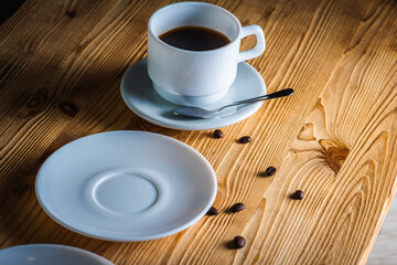 close up view, cup of white coffee with tea plates on wooden surface with space. Morning coffee concept
