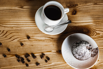 Classic espresso, coffee with coffee chip muffin with coffee beans on an old wooden table. Morning coffee. Top view.