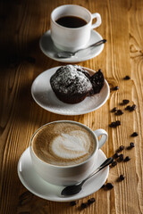 Classic espresso, coffee with coffee chip muffin with coffee beans on an old wooden table. Morning coffee. Top view.
