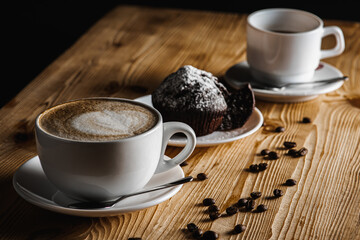 Classic espresso, coffee with coffee chip muffin with coffee beans on an old wooden table. Morning coffee. Top view.