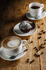 Classic espresso, coffee with coffee chip muffin with coffee beans on an old wooden table. Morning coffee. Top view.