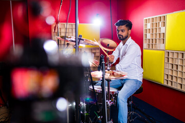 Young arabic man in a professional recording studio