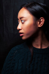 pretty young asian girl posing sensitive on black background, lifestyle people concept