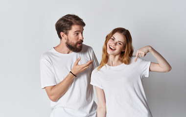 couple in love man and woman in the same t-shirt friends light background