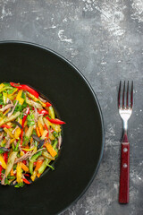 top view delicious vegetable salad inside plate on a grey background color meal health food photo