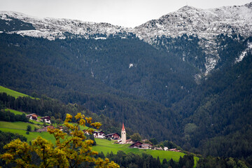 swiss village with church in the mountains