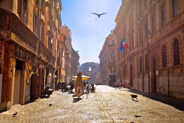 Colorful historic street of Rome sun haze view
