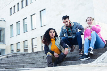 Obraz premium cute group of teenages at the building of university with books huggings, diversity nations real students lifestyle