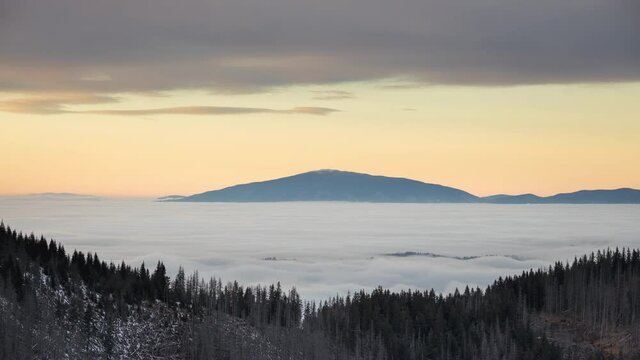 Babia Gora in the clouds. Sunset over Tatra mountains seen from Gesia Szyja on the Polish-Slovak border.