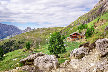 Fototapeta na wymiar view from trekking trail on wooden house in the austrian dolomites
